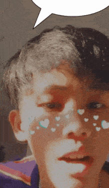 a young boy with hearts on his face and a speech bubble