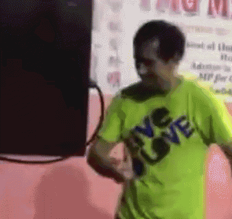 a man wearing a green shirt that says love is dancing