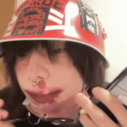 a person wearing a red helmet with a sticker on it that says ' tokyo '