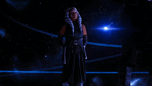 a woman is holding a blue light saber in her hand