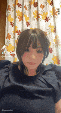 a woman is standing in front of a floral curtain with tiktok written on the bottom right
