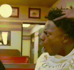 a man with a tattoo on his head is sitting in a diner .