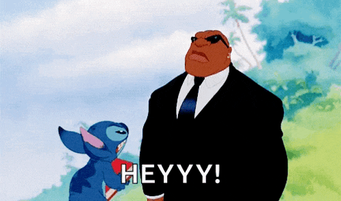 a cartoon of a man in a suit and tie standing next to stitch saying heyyy!
