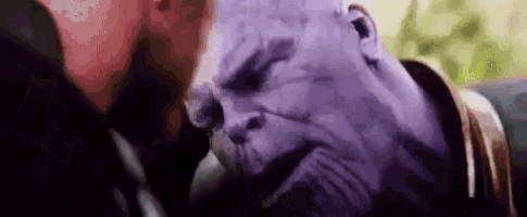 a close up of a person 's face with a purple head and a purple face .