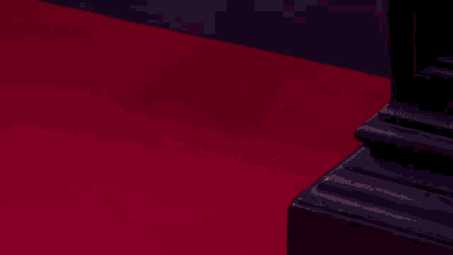 a blurred image of a person walking on a red floor