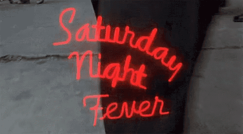 a neon sign says saturday night fever on it
