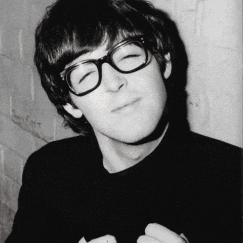 a young man wearing glasses and a black shirt