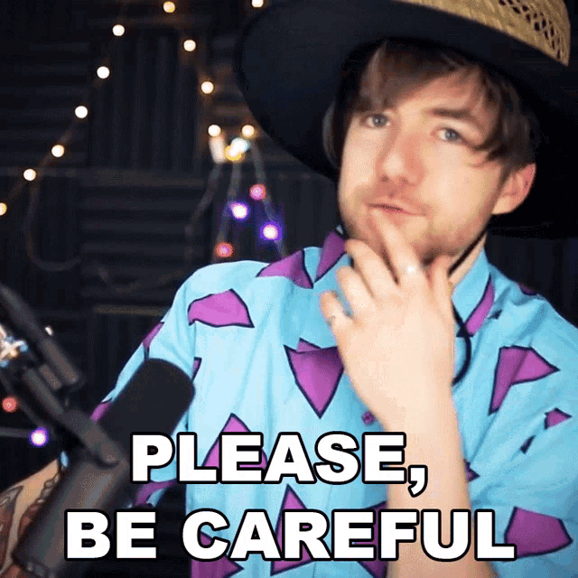 a man wearing a cowboy hat and a shirt that says please be careful
