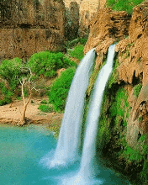 a waterfall is surrounded by trees and cliffs and is surrounded by a body of water