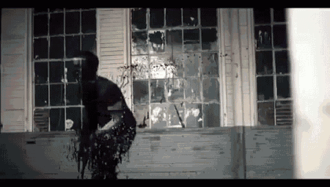 a person is standing in front of a window with blood coming out of it