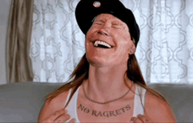 a man with a tattoo that says no regrets on his chest
