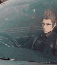 a man is sitting in the driver 's seat of a car with glasses on .