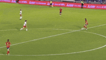 a soccer game is being played on a field with a selecci sign in the background