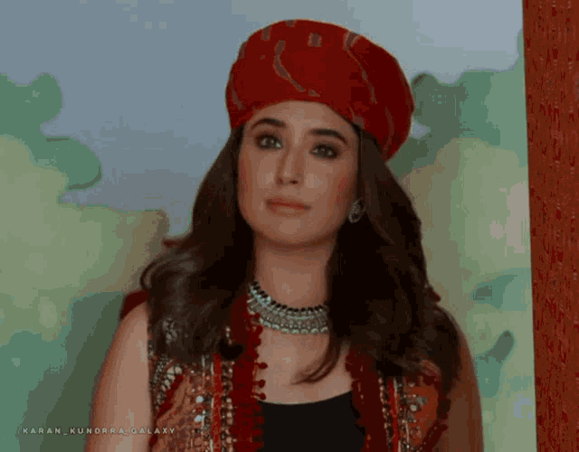 a woman wearing a turban and a necklace with the name karan kundrai galaxy on the bottom right