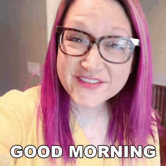a woman with purple hair wearing glasses and a yellow shirt says good morning