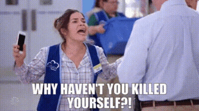 a woman is holding a cell phone in her hand and screaming at a man in a store .
