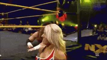 a woman in a wrestling ring with the word nxt on the bottom