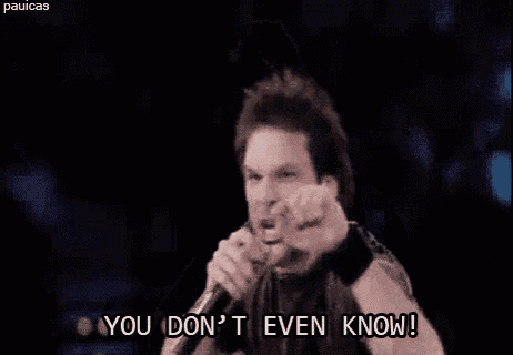a man is singing into a microphone with the words `` you don 't even know '' .
