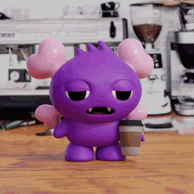 a purple monster holding a cup of coffee