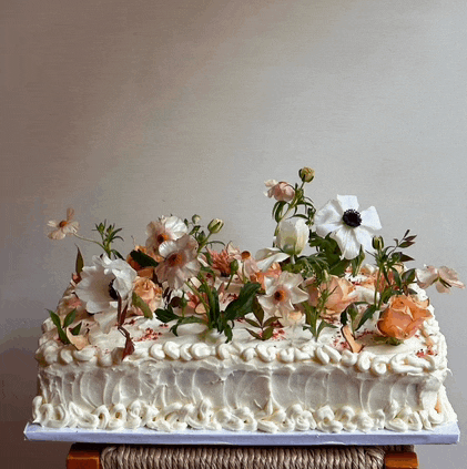 a cake with flowers on top of it is on a table