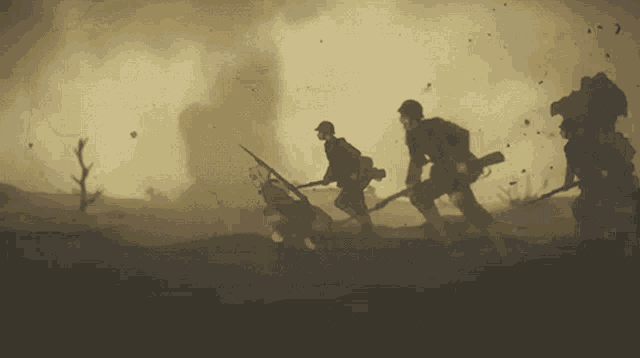 a group of soldiers are walking through a field with smoke coming out of the background