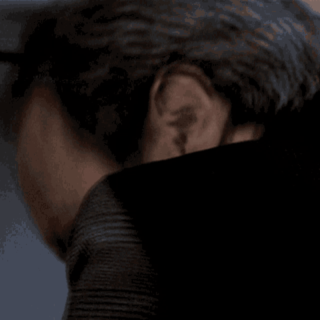 a close up of a man 's face with a dark background