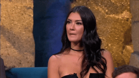 a woman wearing a choker is sitting in front of a gold background