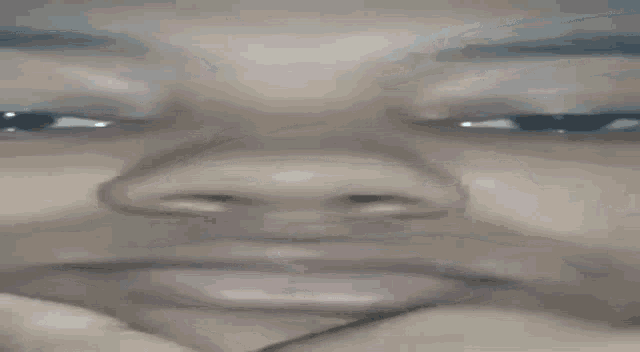 a close up of a person 's face with a hand on their chin