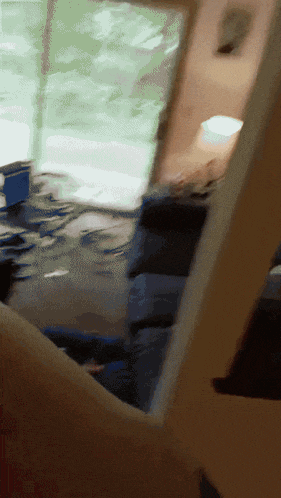 a blurred image of a person 's arm holding a piece of wood