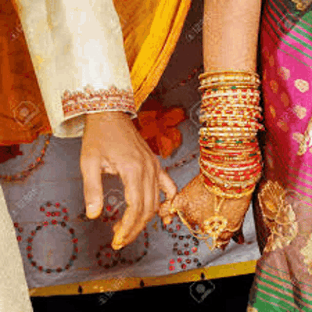a bride and groom are holding hands on their wedding day .