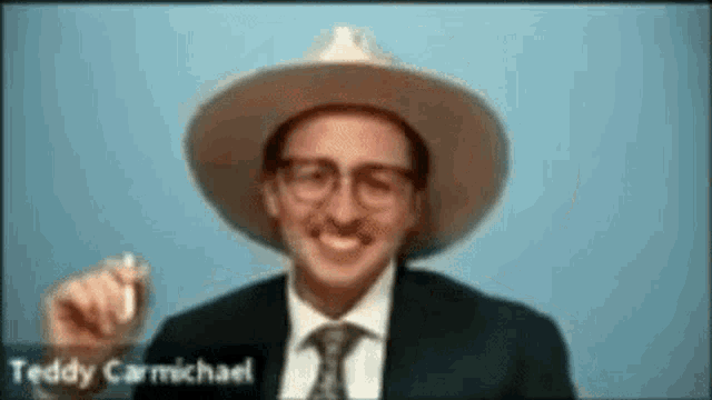 a man wearing a hat and tie with the name teddy carmichael on the bottom