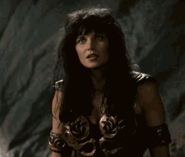 a woman with long black hair and blue eyes is wearing a very ornate outfit