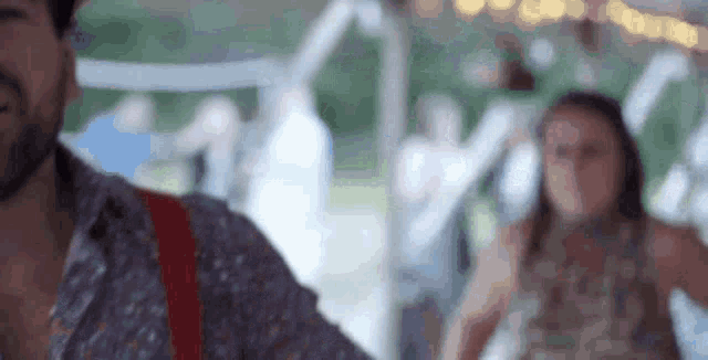 a man is playing a guitar and a woman is dancing in a tent .