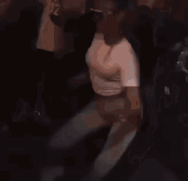 a woman in white pants and sunglasses is dancing in a crowd