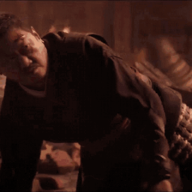 a man in a dark room with a bloody head