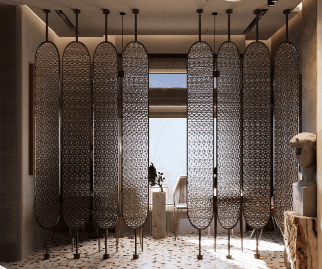 a room with a statue in the corner and a room divider with a pattern on it
