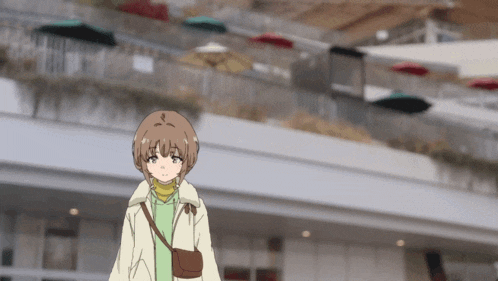 a girl with a purse on her shoulder stands in front of a building