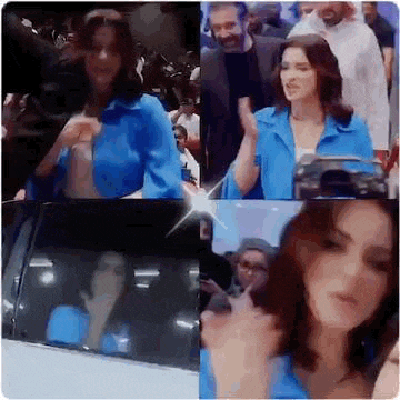 a woman in a blue jacket is standing next to a car in front of a crowd .