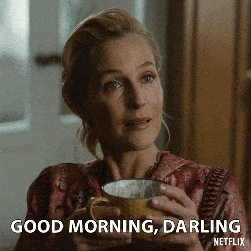 a woman is holding a cup of coffee and says good morning darling on the bottom
