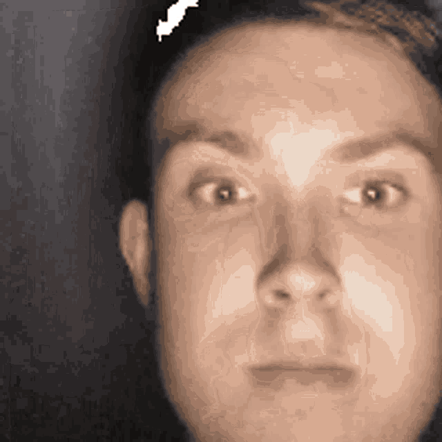 a close up of a man 's face with an arrow pointing to his head