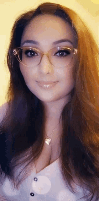 a woman wearing glasses and a white shirt with buttons