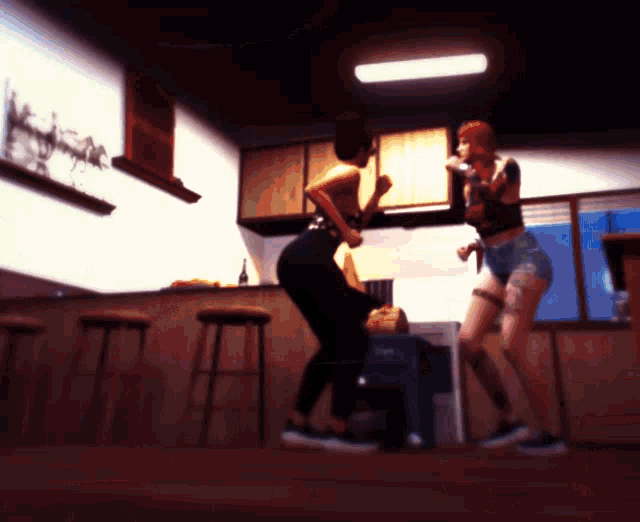 two women are dancing in a kitchen with stools and cabinets