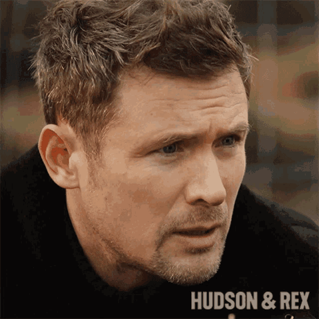 a close up of a man 's face with the words hudson & rex on the bottom right