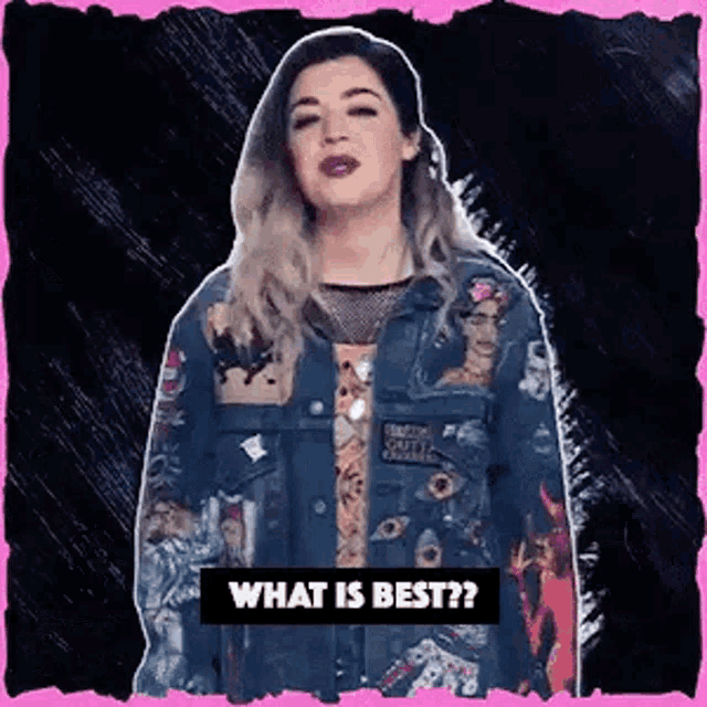 a woman in a denim jacket is standing in front of a pink background and asking what is best .