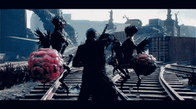 a video game scene with a man standing on train tracks fighting monsters