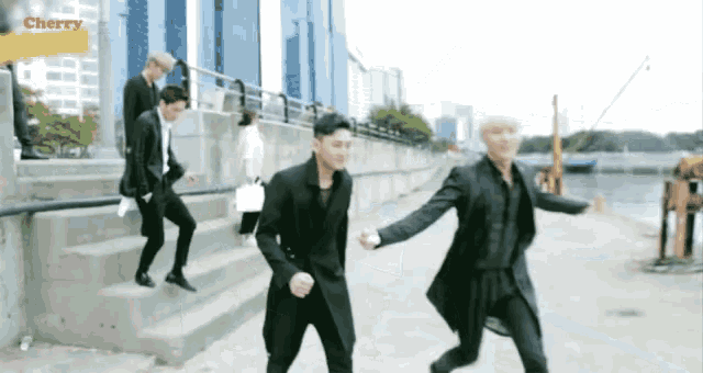 a group of men are walking down stairs with the word cherry on the bottom right
