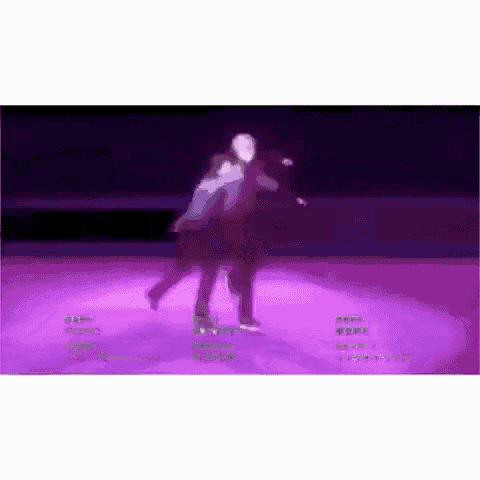 a couple of people are standing on top of a purple ice rink .