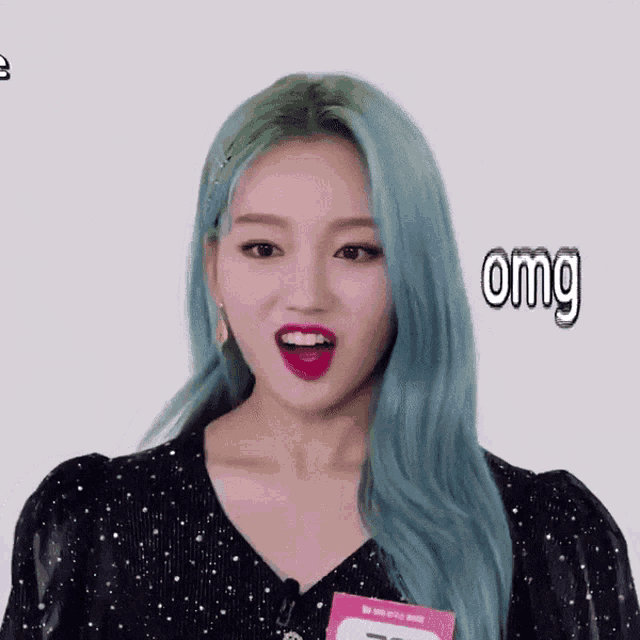 a woman with blue hair and a name tag that says omg on it