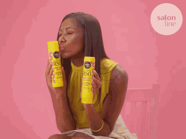 a woman holds two bottles of salon line shampoo