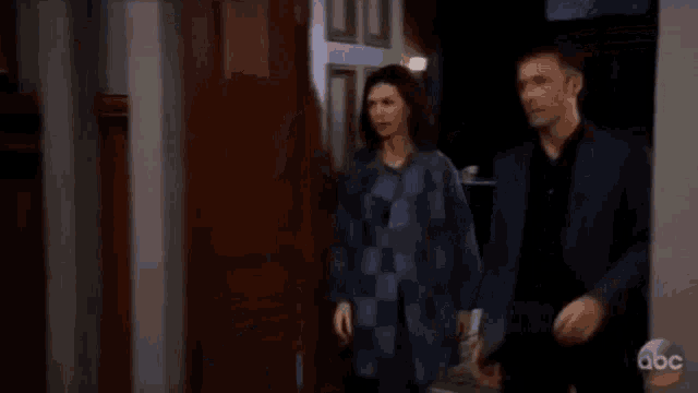 a man and a woman are looking at each other .